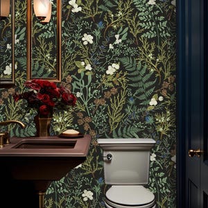 May include: A small bathroom with a white toilet and a dark brown sink. The walls are covered in a black and green floral wallpaper with a botanical design.