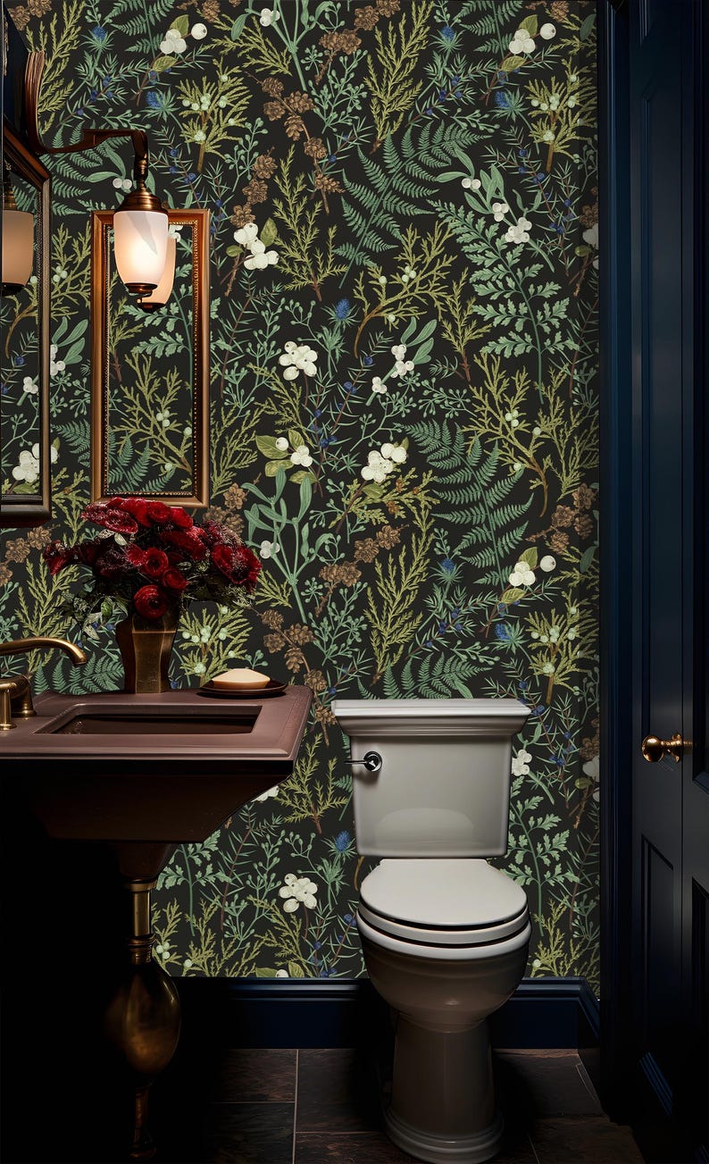 May include: A small bathroom with a white toilet and a dark brown sink. The walls are covered in a black and green floral wallpaper with a botanical design.
