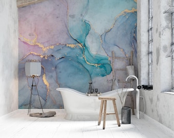 May include: A white bathtub with gold accents sits in a bathroom with a large abstract wall mural featuring blue, purple, and gold colors. A wooden stool and a black floor lamp are also in the room.