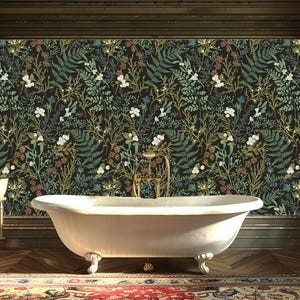 May include: A white clawfoot bathtub sits in a bathroom with a dark wood floor and a floral wallpaper. The wallpaper features a dark background with green, white, and brown floral patterns.
