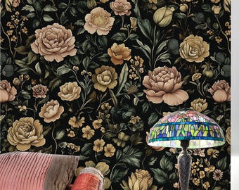 May include: A bedroom scene featuring a floral wallpaper with large, detailed blooms in shades of beige, yellow, and peach against a black background. A bed with pink and brown pillows and a decorative lamp with a stained glass shade are visible.
