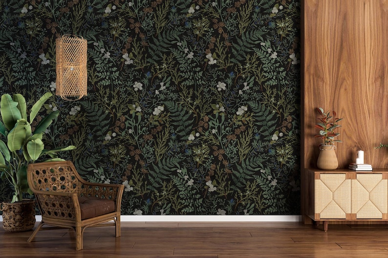 May include: A dark green and brown floral wallpaper with a repeating pattern of leaves and flowers. The wallpaper is shown in a room with a wicker chair and a wooden side table.