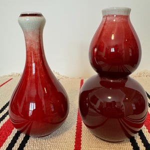 A pair of sacrificial red vases