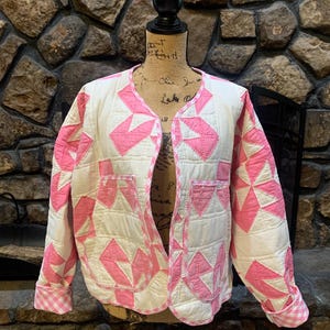 Pink and white quilted jacket with gingham trim.