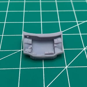 May include: A light purple plastic model car hood with detailed interior features.