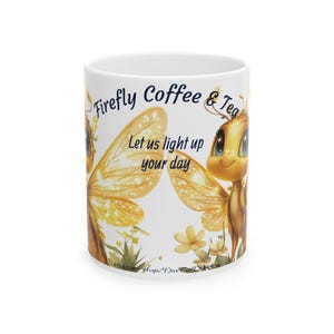 May include: White ceramic coffee mug with a design of two cartoon fireflies with glowing wings. The text "Firefly Coffee & Tea" and "Let us light up your day" is printed on the mug.