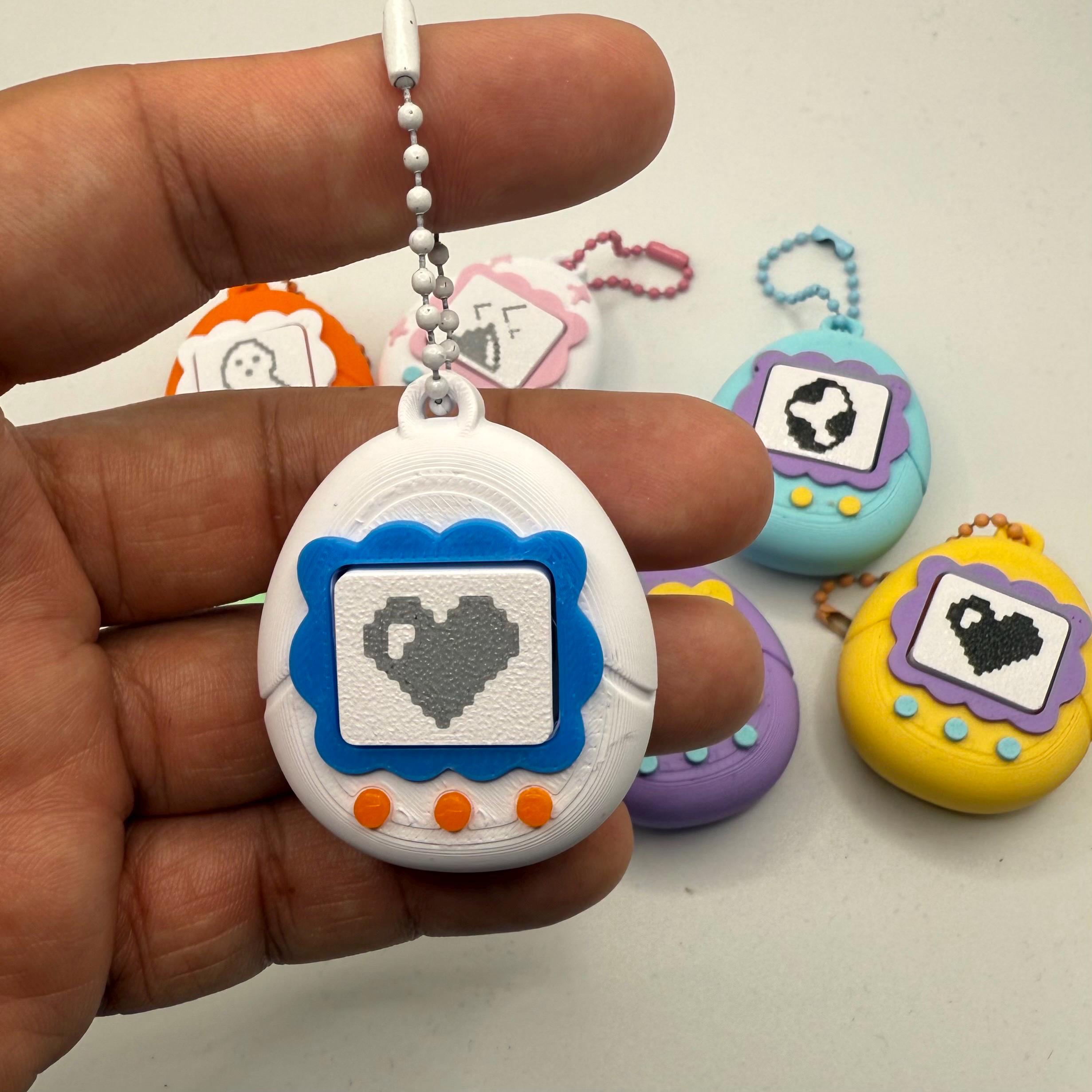 たまごっちフィジェットキーチェーン：レトロなクリック感覚玩具