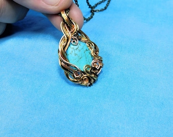 May include: A pendant featuring an oval turquoise stone with dark veining, encased in intricate, swirling copper and bronze wire wrapping. The pendant is suspended from a dark metal chain, showcasing a detailed metalwork design around the stone.