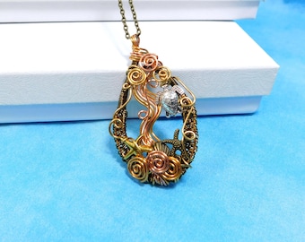 May include: A teardrop-shaped pendant necklace made of wire wrapped in copper, gold, and silver tones. The pendant features a sea turtle, starfish, and seashells.
