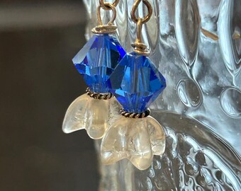 Clear frosty flower Czech Glass Dropped by Blue swarovski cones. Silver wire earrings