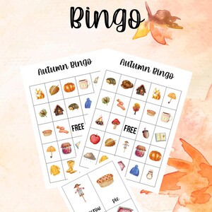 May include: Watercolor-style "Autumn Bingo" game sheets with fall-themed illustrations. The game cards feature images of pumpkins, acorns, and other seasonal items. The background is a soft, warm color with decorative leaf accents.