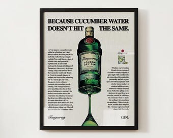 May include: A vintage advertisement for Tanqueray London Dry Gin. The ad features a bottle of gin with a green label and a glass of gin with a cucumber garnish. The text reads "Because cucumber water doesn't hit the same."
