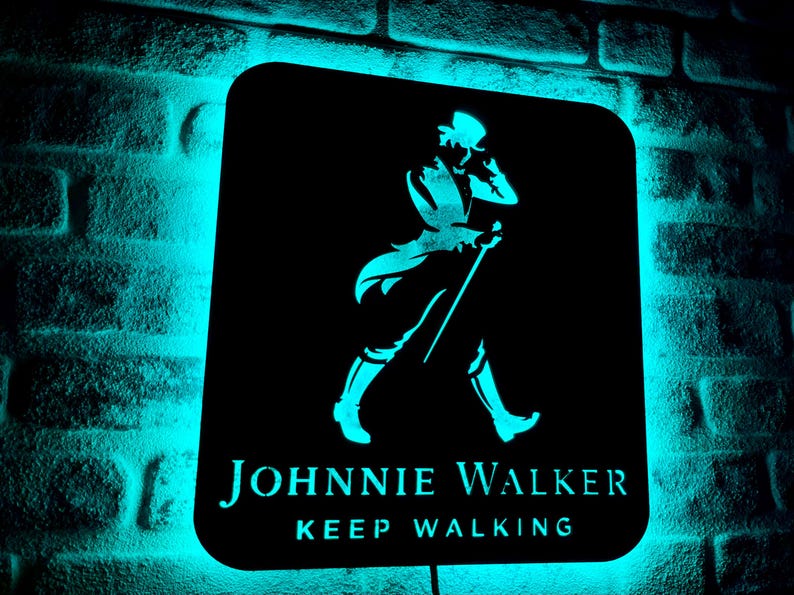 May include: A black metal sign with a blue neon glow. The sign features a silhouette of a man walking with a cane and the text "JOHNNIE WALKER KEEP WALKING."