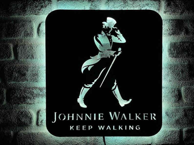 May include: Black and white silhouette of a man walking with a stick, with the text "JOHNNIE WALKER KEEP WALKING" below.