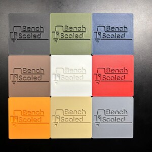Plastic color palette, showing 9 different available plastic colors, The colors are black, green, blue, brown, white, red, orange, beige and gray.