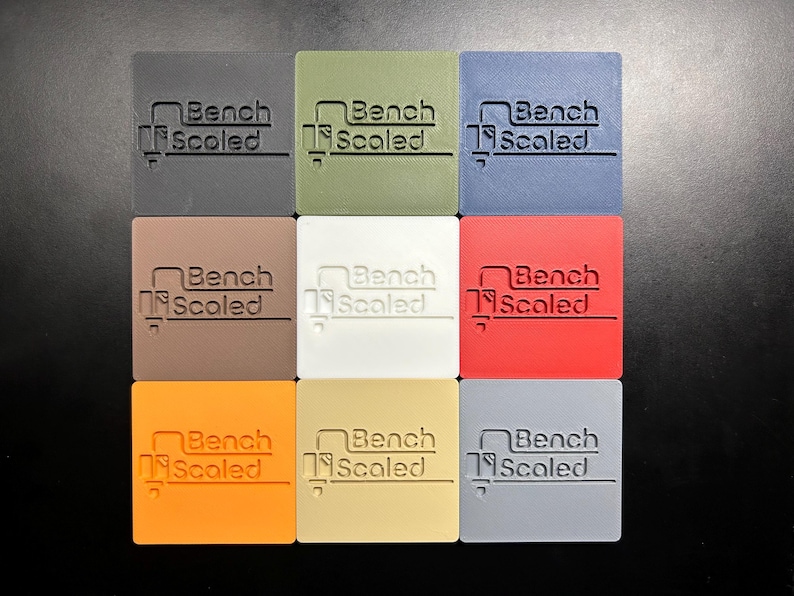 Plastic color palette, showing 9 different available plastic colors, The colors are black, green, blue, brown, white, red, orange, beige and gray.