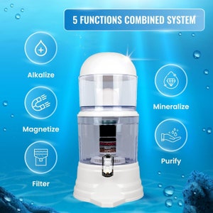 May include: White water filter pitcher with a clear container and multiple filter stages. The pitcher has a spout and a handle. The image shows five functions of the filter: alkalize, magnetize, mineralize, purify, and filter.