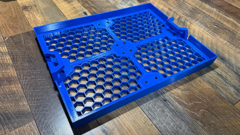 Puede incluir: Una bandeja de pl&aacute;stico azul con un patr&oacute;n de panal. La bandeja est&aacute; dividida en cuatro secciones y tiene un borde elevado.