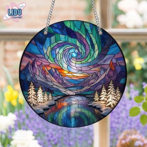 May include: Round stained glass window art depicting a mountain landscape with a river, trees, and an aurora borealis design. The artwork features a vibrant color palette of blues, greens, purples, and oranges, with a silver chain for hanging.