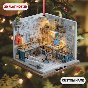 May include: A detailed miniature architectural workshop ornament, suspended by a red ribbon. The ornament showcases a miniature interior with blueprints, tools, and a laptop. The text "2D FLAT NOT 3D" is at the top, and "CUSTOM NAME" is at the bottom.