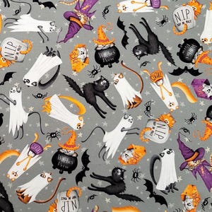 May include: Halloween-themed fabric with a gray background featuring cartoon cats, ghosts, bats, spiders, witch cats, cauldrons, and tombstones. The tombstones read "NIP" and the cauldrons read "Witches Brew". The fabric is suitable for crafting and seasonal projects.