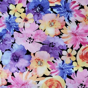 May include: A fabric with a floral pattern featuring watercolor-style flowers in shades of pink, purple, yellow, and orange against a black background. The flowers vary in size and shape, creating a vibrant and artistic design.