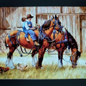 May include: Two children, one wearing a brown cowboy hat, ride a brown and white horse in front of a wooden barn. The horse is pulling a second horse, also brown and white, with a blue harness. The horses are standing in a field of green grass with a few chickens.