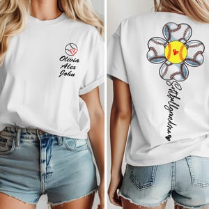 May include: White t-shirt with a softball flower design on the back and the text "Softball Grandma" and a heart. The front of the shirt has a softball with a heart and the text "Olivia Alex John".
