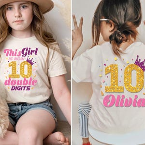 May include: A white t-shirt with a pink and gold design that says "This Girl is Now 10 Double Digits" on the front and a gold number 10 with a purple crown and the name "Olivia" in pink on the back.