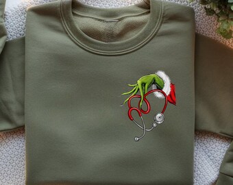Felpa natalizia divertente da infermiera: design con stetoscopio medico e Grinch