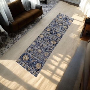 May include: A blue and gold patterned runner rug with a floral design. The rug is laid out on a light wood floor.