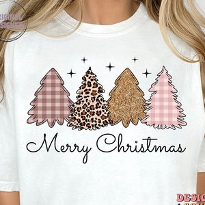 May include: White t-shirt with a graphic of three Christmas trees. The trees are decorated with pink and white gingham, leopard print, and gold glitter. The text "Merry Christmas" is printed below the trees.