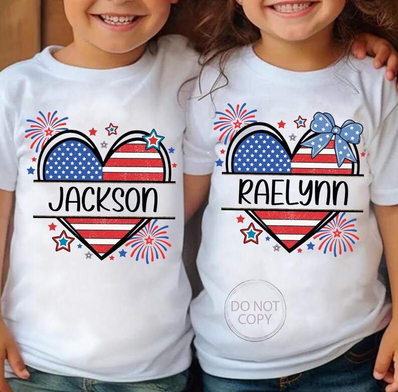 May include: White t-shirts with a patriotic heart design. The heart is split into sections with a blue star field and red and white stripes. The names "JACKSON" and "RAELYNN" are printed below the heart.
