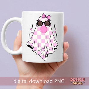 May include: A white ceramic mug with a pink and white checkered ghost wearing pink sunglasses and a pink bow. The ghost has a pink bubble coming out of its mouth. The mug has a black outline and the text "digital download PNG" and "DESIGN SOUL" in pink.