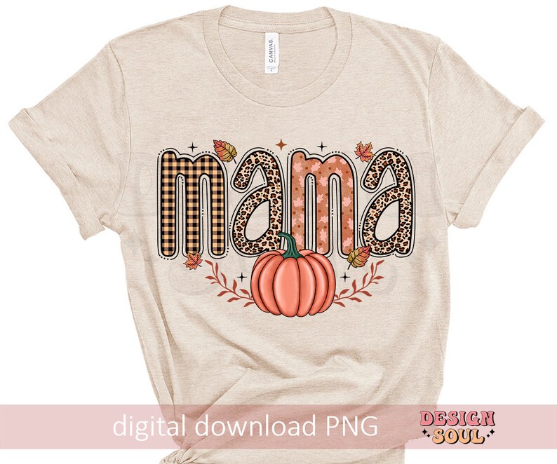 May include: A beige t-shirt with the word "mama" in a fall-themed font with a pumpkin and leaves. The text is in a variety of patterns including plaid, leopard print, and floral.
