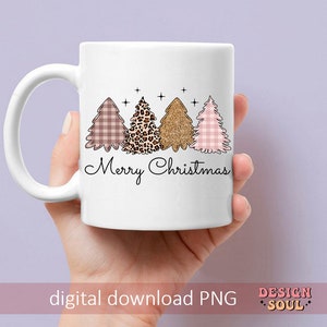 May include: White ceramic mug with a pink, brown, and gold Christmas tree design and the text "Merry Christmas".