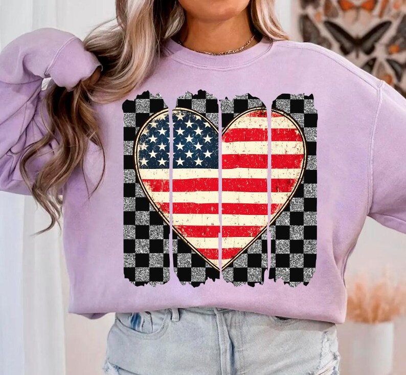 May include: A lavender sweatshirt with a distressed checkered design and a heart-shaped American flag graphic.