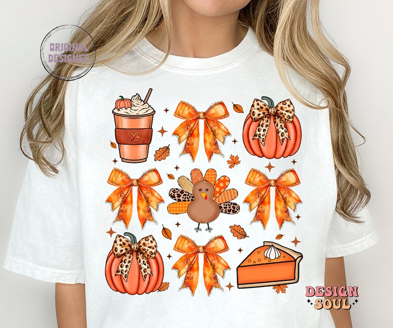 May include: White t-shirt with a Thanksgiving-themed design featuring a pumpkin, a turkey, a pie, a coffee cup, and bows with a leopard print pattern.