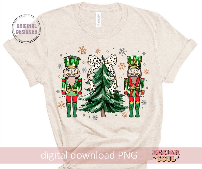 May include: Beige t-shirt with a festive Christmas design. The design features two nutcrackers in green and red uniforms, a green Christmas tree with a black and white polka dot bow, and snowflakes. The text "digital download PNG" is at the bottom.