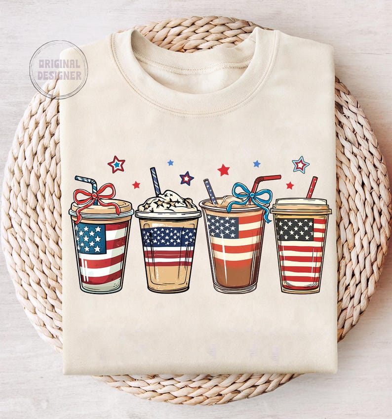 May include: Four iced coffee drinks with red, white, and blue patriotic designs. The drinks are in clear cups with lids and straws. The cups are decorated with stars and stripes.