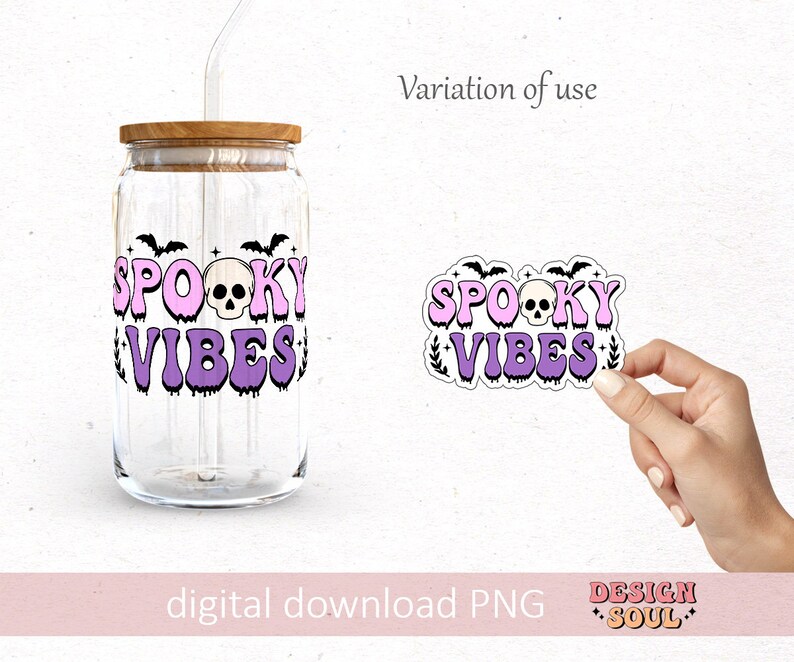 May include: A purple and pink sticker with the text "Spooky Vibes" and a skull graphic. The sticker is on a white background and is being held by a hand.
