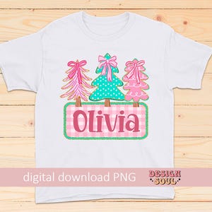 May include: White t-shirt featuring a design with three Christmas trees in pink and teal, each adorned with a bow. The name "Olivia" is displayed on a pink and white checkered background. The words "digital download PNG" are also visible.