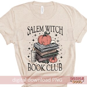 May include: A beige t-shirt with the text "Salem Witch Book Club" printed on it. The design features a stack of books, a pumpkin, a skull, and a candle.