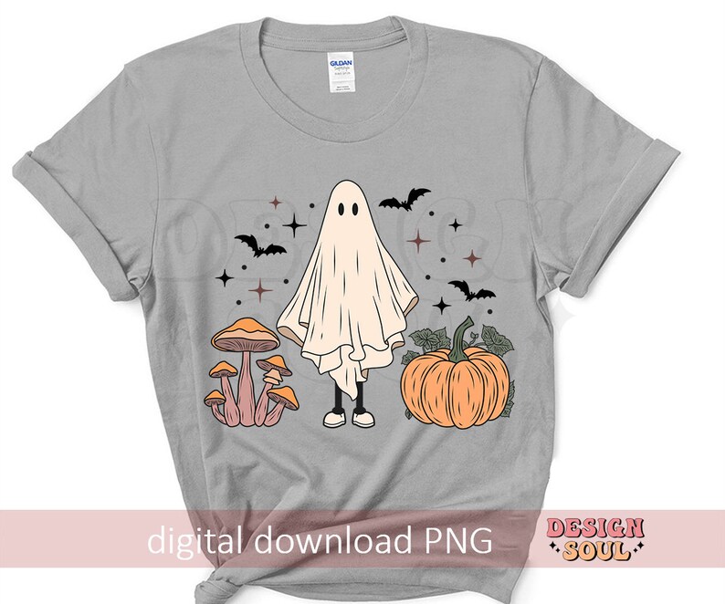May include: A gray t-shirt with a white ghost, mushrooms, and a pumpkin. The ghost is wearing a white sheet and has a friendly face. The mushrooms are brown and white with orange tops. The pumpkin is orange with a green stem. The text "digital download PNG" is at the bottom of the shirt.