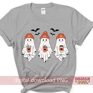 May include: A light gray t-shirt featuring three cartoon ghosts wearing orange pumpkin beanies and holding fall-themed beverages. Black bats fly above the ghosts. The text "digital download PNG" is at the bottom.