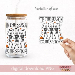 May include: A digital download of a graphic design featuring three skeletons dancing with the text "Tis the season to be spooky" and pumpkins. The design is shown on a clear glass jar with a wooden lid and a straw.