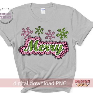 May include: A grey t-shirt with a pink and green "Merry" design featuring snowflakes. The text is in a glittery font and the snowflakes are pink and green.