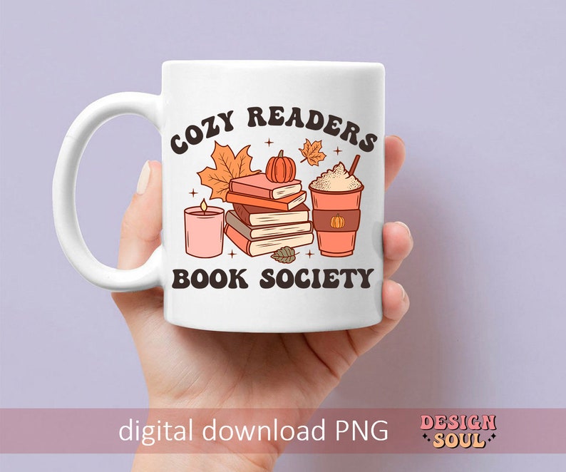 May include: White ceramic mug with a brown and orange design. The mug features a stack of books, a candle, a pumpkin, and a cup of coffee. The text on the mug reads "Cozy Readers Book Society".