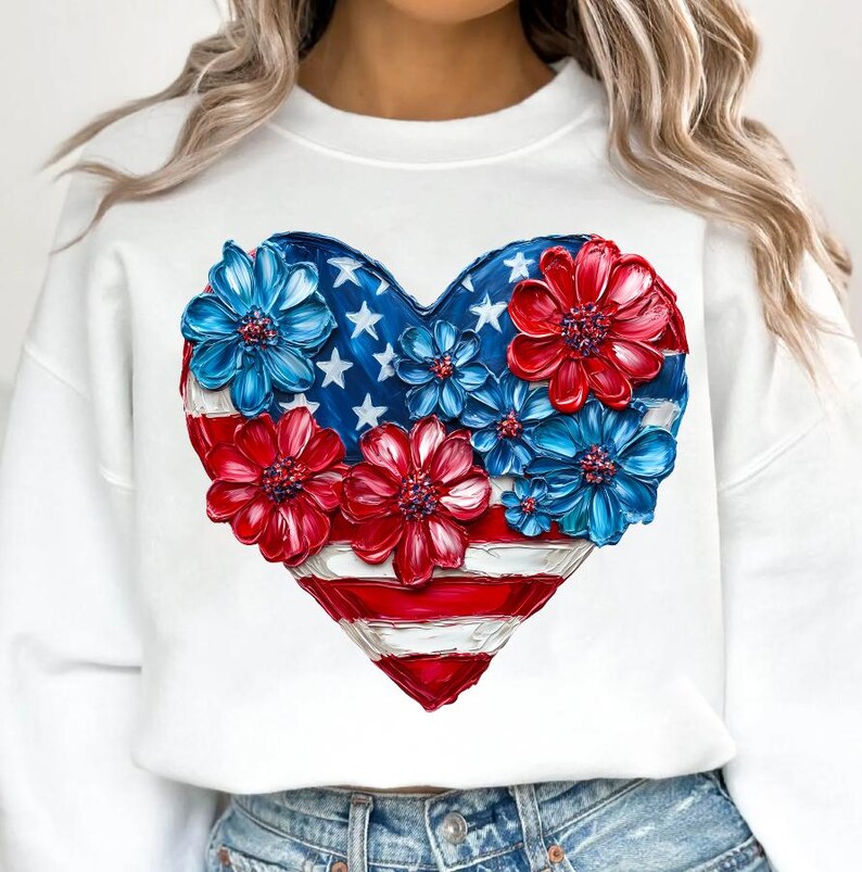May include: White sweatshirt with a red, white, and blue heart-shaped design. The heart is made up of flowers and the American flag.
