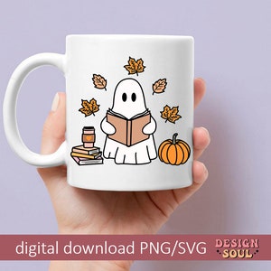 May include: White ceramic mug with a ghost reading a book, surrounded by fall leaves, a pumpkin, and a stack of books. The mug has a handle and the text "DESIGN SOUL" is printed on the bottom.